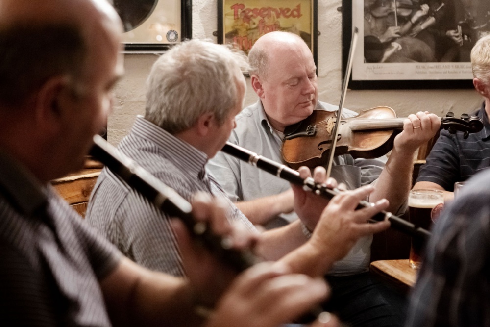 Traditional music at Gus O'Connor's, Doolin — supporting local Irish communities
